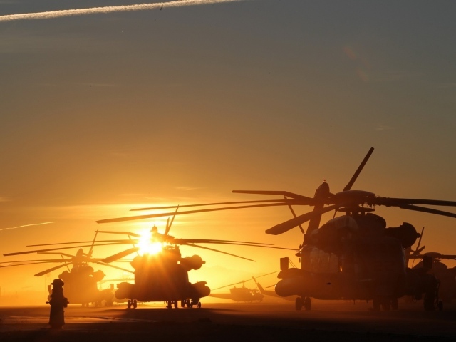 Several helicopter at sunset